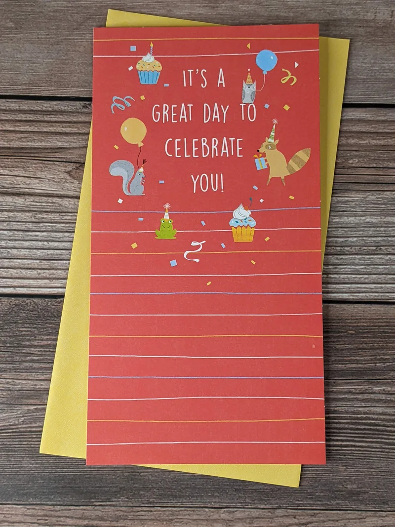 A birthday greeting card with a red cover that has images of party decorations, party food, and party animals.